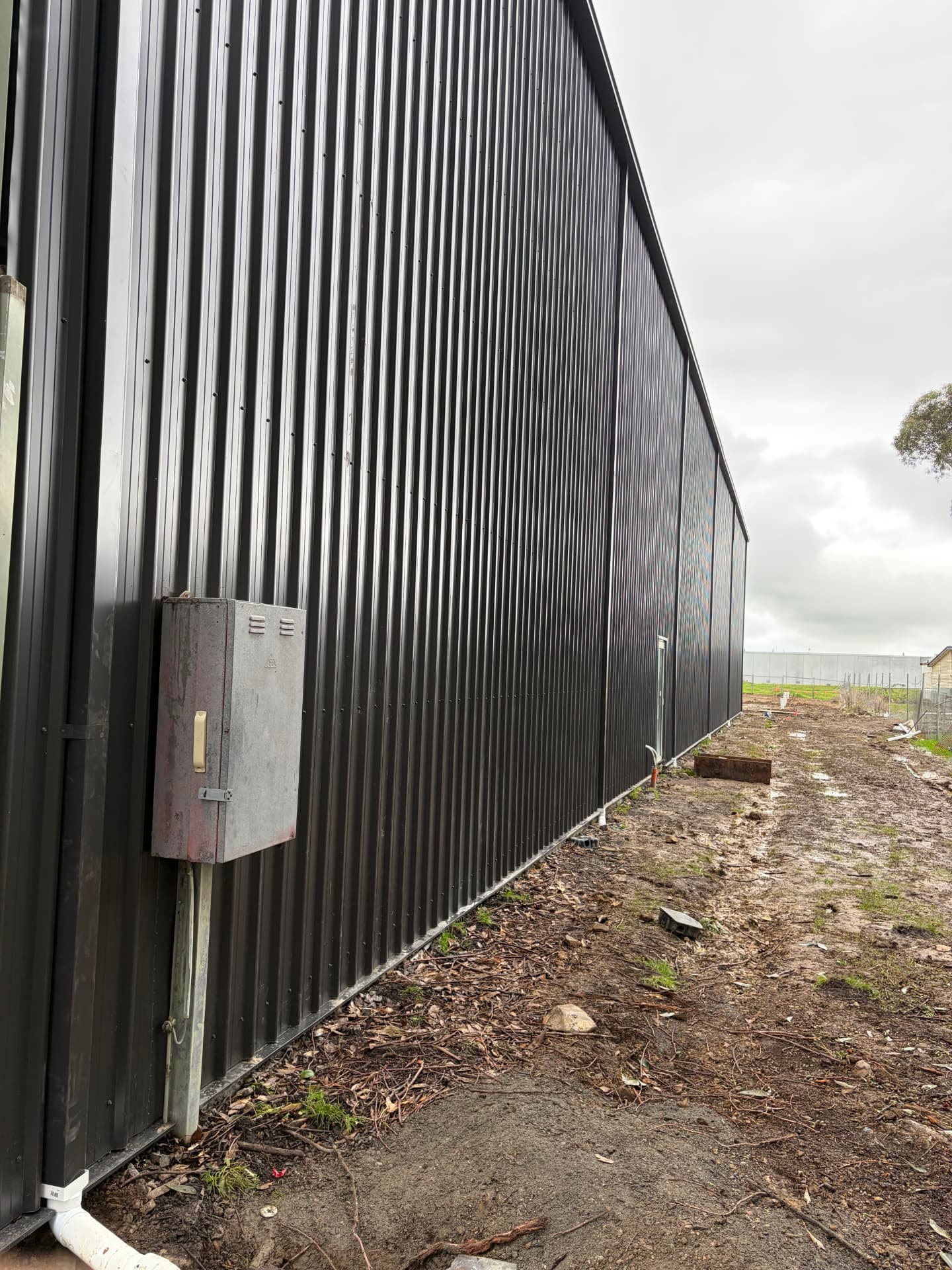Dark corrugated metal cladding on a farm shed