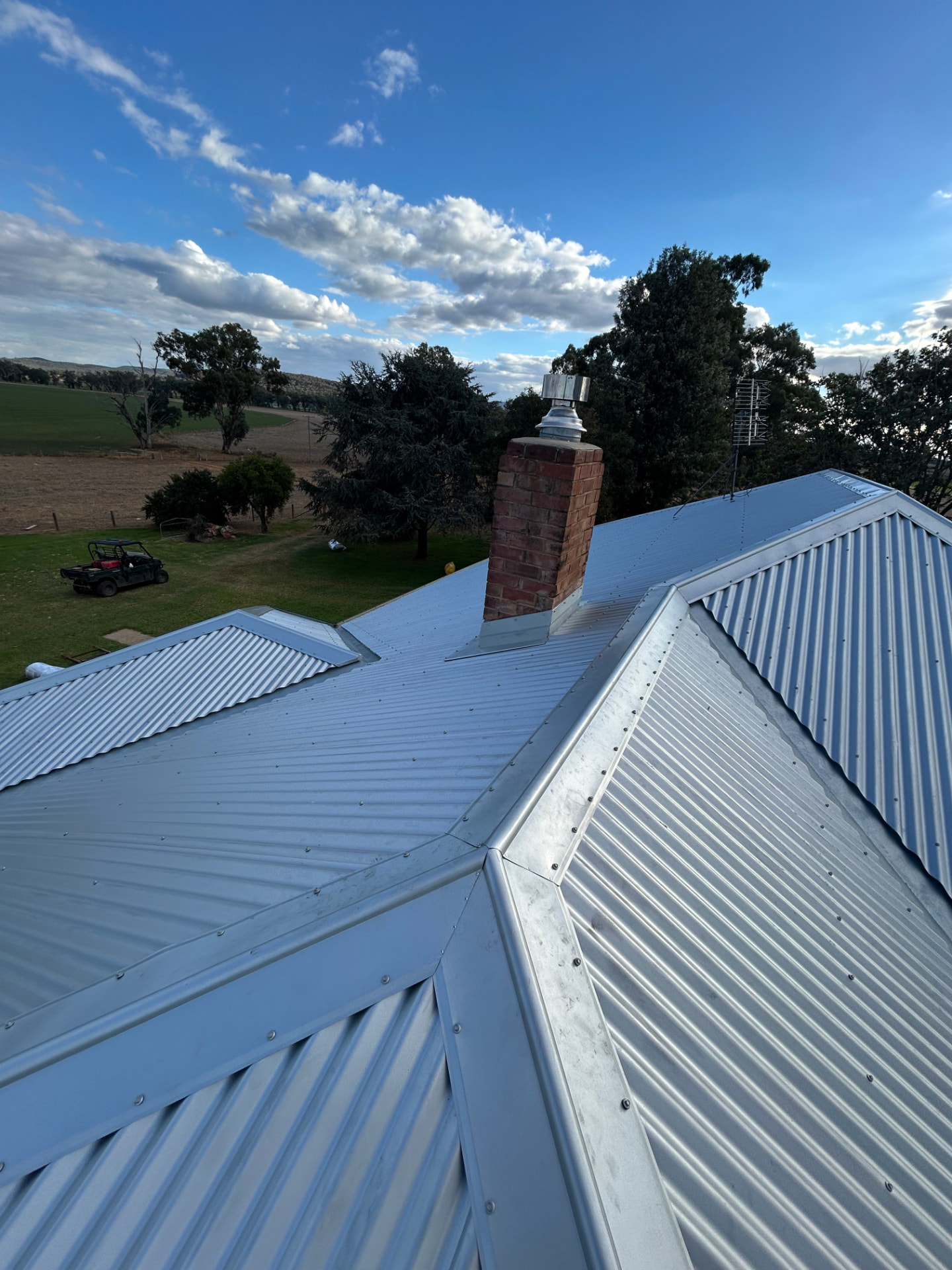 Finished corrugated Colorbond roof replacing the old tiled roof, with brick chimney