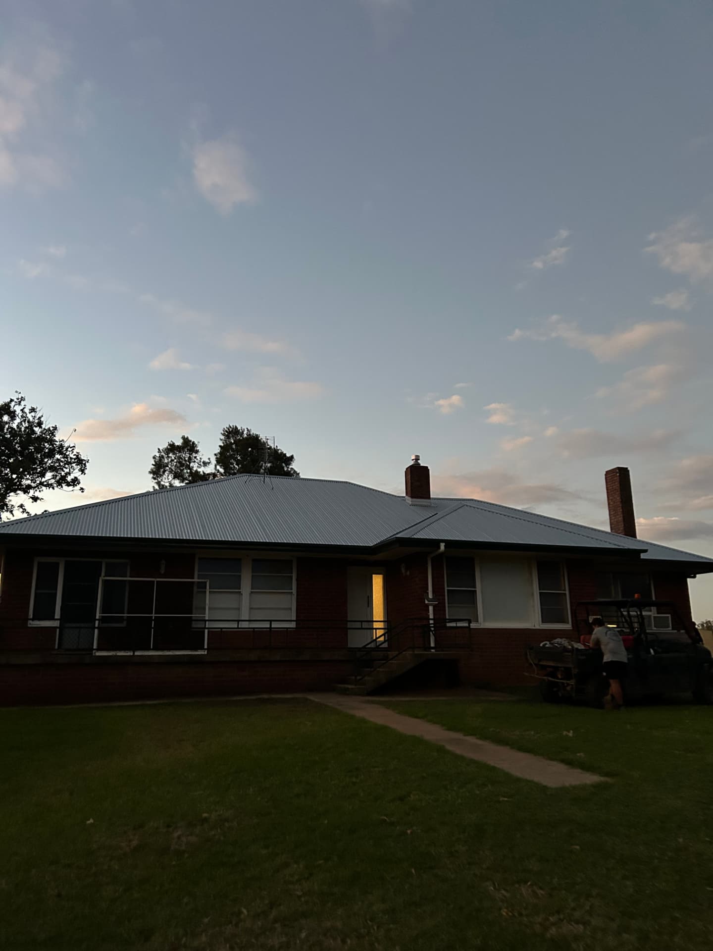 New zincalume roof at dusk on a brick home